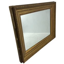 19th century giltwood and gesso rectangular wall mirror, the moulded frame decorated with bay leaf garland and acanthus leaf motifs, stepped and foliate moulded slips enclosing bevelled mirror plate
