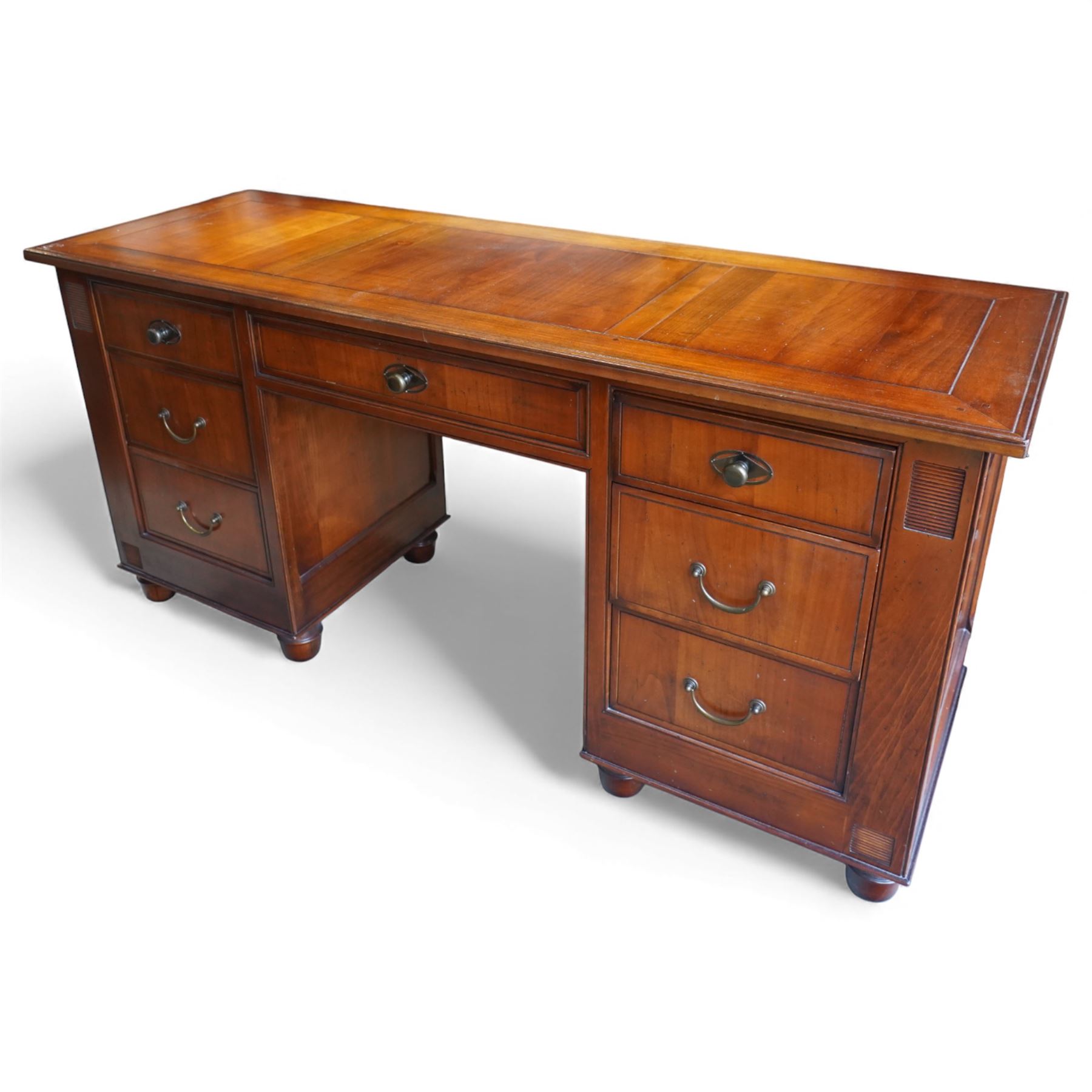 And So To Bed - French cherry wood twin pedestal dressing table, the rectangular top over seven drawers arranged with a central drawer and three drawers to each pedestal, panelled sides with louvred detail, raised on turned bun feet
