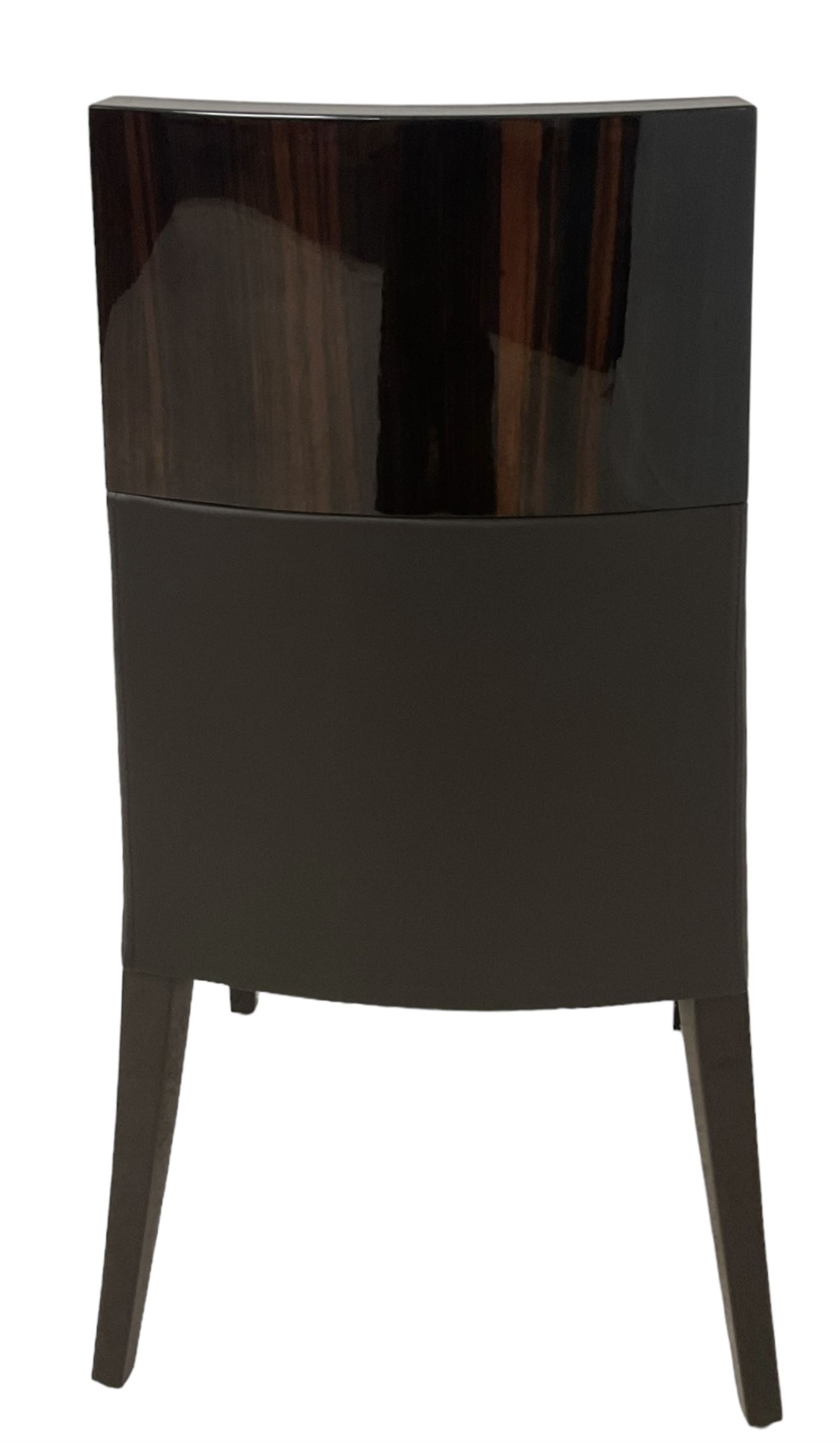 Giorgio Collection - Art Deco design macassar ebony 'Luna' extending dining table, oval top with quarter-matched veneer and stringing, raised on a curved V-shaped pedestal with oval base; with matching set of dining chairs, high macassar ebony back, the lower half and seat upholstered in black leather, on ebonised tapering supports, retailed by Harrods