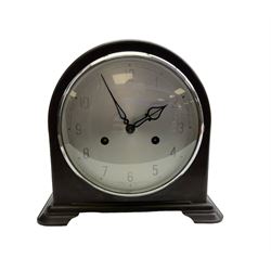 Enfield- English 1950's 8-day mantle clock in a round topped brown Bakelite case on splayed feet, with a glazed chrome bezel and silvered dial with Arabic numerals and original pierced hands, twin train spring driven movement, sounding the hours and half-hours on a coiled gong. With pendulum & key.  