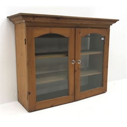  Early 20th century pine bookcase, two glazed doors enclosing two shelves, W123cm, H94cm, D43cm  