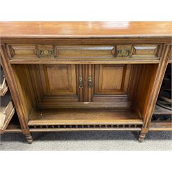 Late Victorian walnut dresser, the raised panelled back fitted with panelled cupboards, shelves and bevelled mirrors, moulded rectangular top over three drawers and cupboards, the left-hand cupboard fitted with two slides and the right-hand cupboard fitted with revolving drinks stand, on turned feet