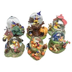 Six Disney Winnie The Pooh snow globes, to include four Halloween examples, including Tigger's Haunted House, together with Winnie The Pooh Gazebo snow globe and Bonfire snow globe, all with boxes