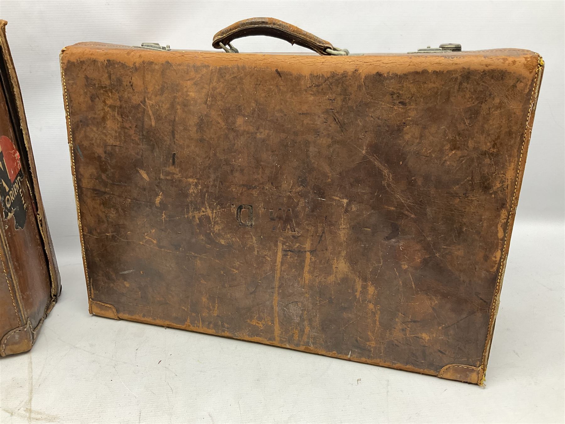Early 20th century leather suitcase marked to the top 'Major P.M. Newton R.E. Crossways, Bridlington, East Yorkshire' 60 x 40cm; another similar leather suitcase marked W.D. to the lid; three post-WW2 respirators; and three unopened pairs of British Army N.B.C. (Nuclear Biological Chemical) No.1 Mk.III Trousers Protective (8)