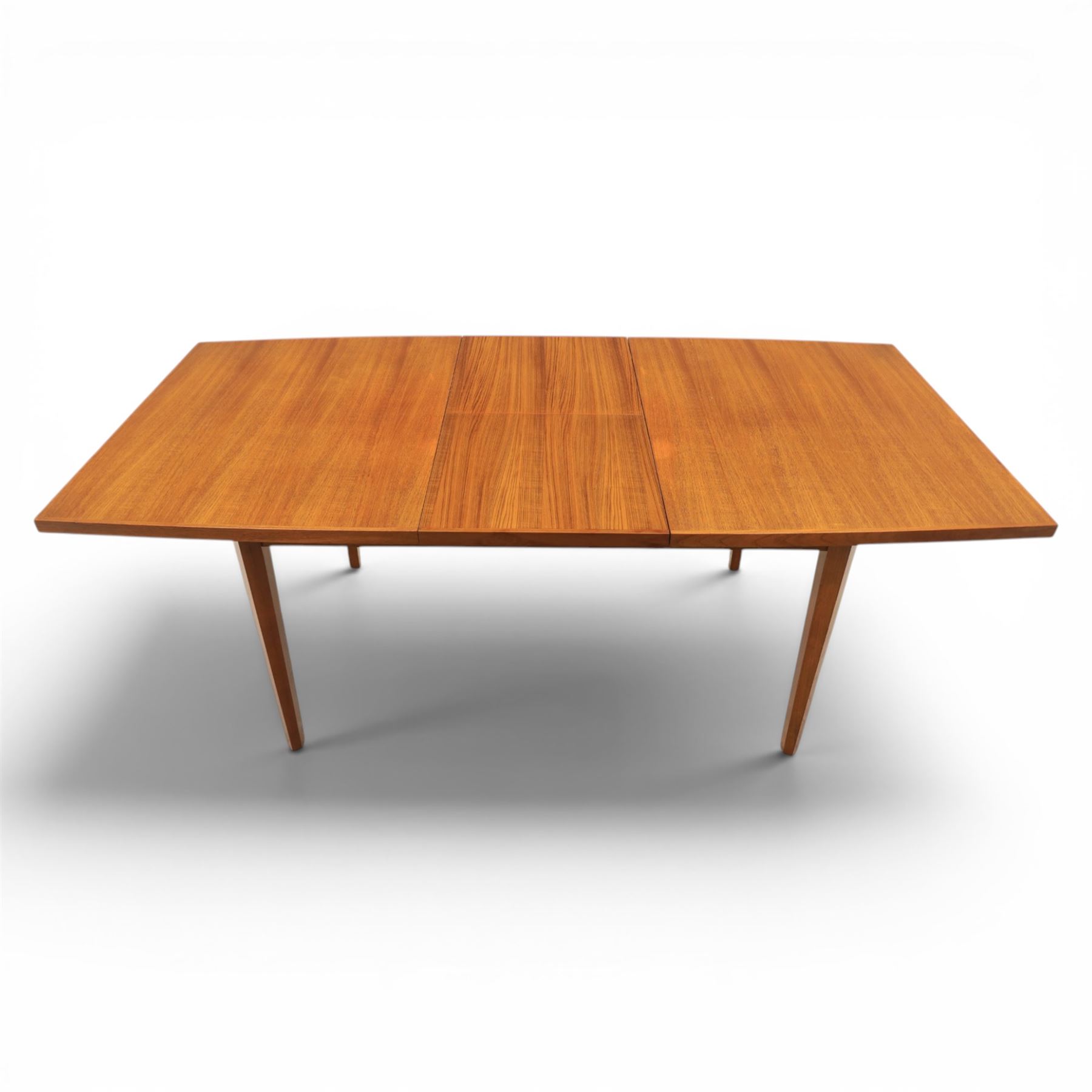 Mid-20th century teak dining table and chairs, with stowable fold over leaf, raised on square tapering legs, the chairs with teak frames and reupholstered green leather seats