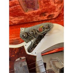 1963 Fender Jazz three-knob bass guitar; impressed with date code 7AUG63A on end of neck and serial no.L08587 on back plate; all original but re-finished in white in the 1970s; sold with photographs of the instrument in the 1960s with original finish and in the 1970s re-finished; L117.5cm; in original hard carrying case; Provenance: the professional guitar of Howard Livett from new to his death in 2005. Howard played in The Humperdincks, the backing group for Englebert Humperdinck, also played in the backing group for Max Bygraves and in the band Hedgehoppers Anonymous. The guitar is also sold with a manuscript letter of provenance from Howard's wife.