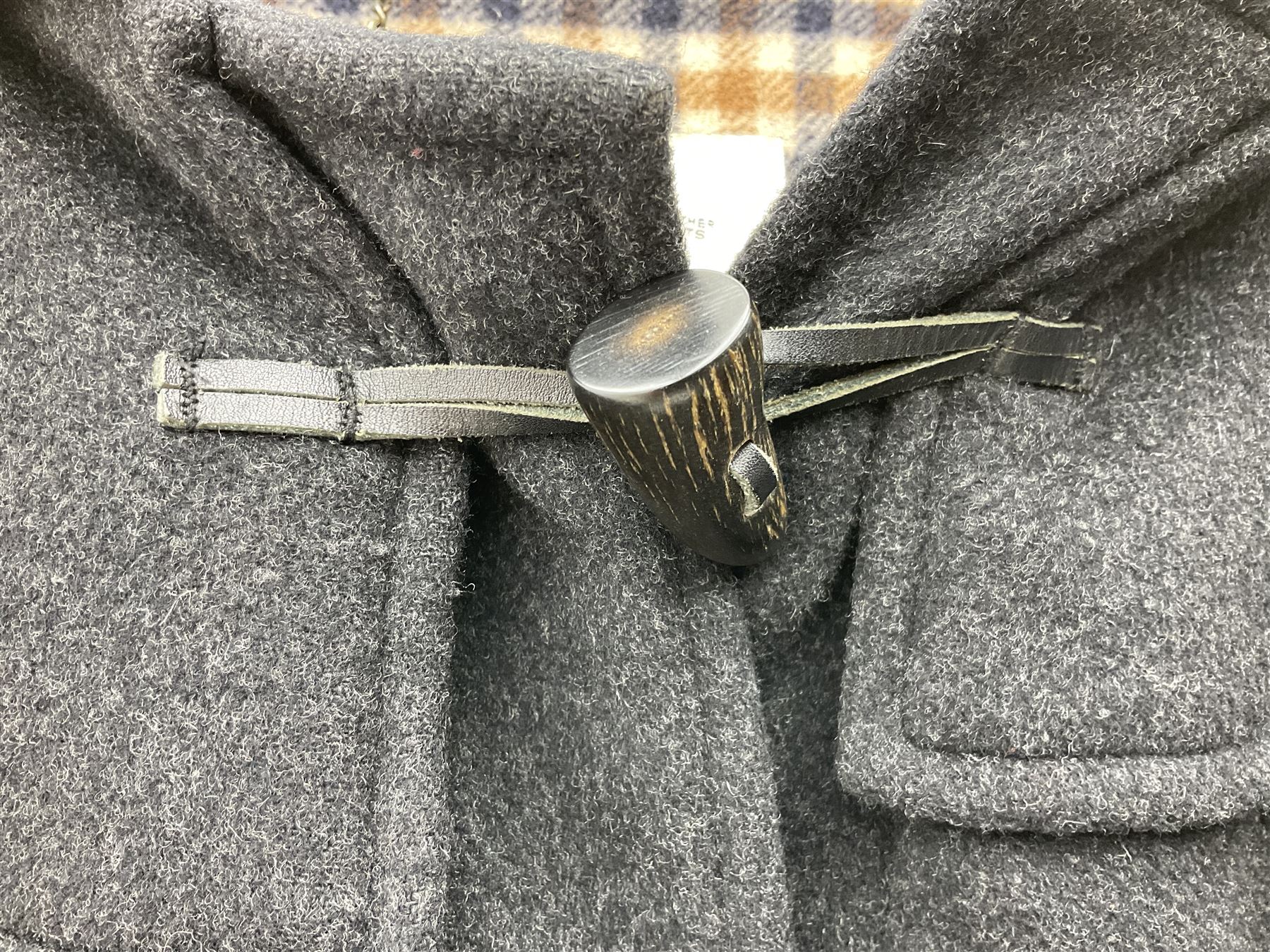 Men's Aquascutum lambs wool herringbone tweed coat with silk lining, 46 Reg, together with a further Men's Aquascutum grey wool duffle coat, with cheque lining and horn buttons, 46