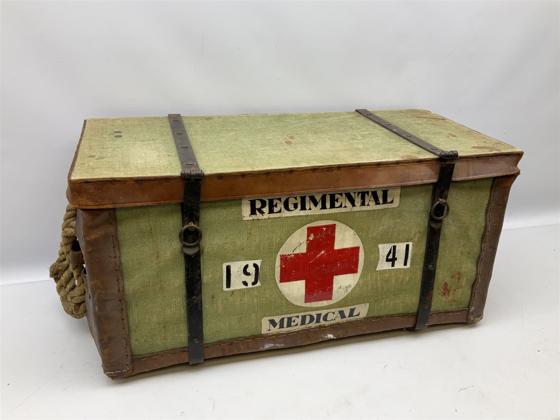 WW2 British Army RAMC 'Regimental Medical Pannier', well marked externally and dated 1941, stamped May 1943 internally, canvas covered wicker form with leather edges, hinged top and fall front with two rope carrying handles, fitted iron locking straps with securing chains; contains various unused field dressings and bandages with WW2 dates and two pillows; original label under lid L79cm
