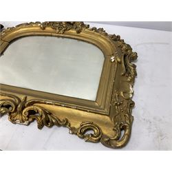 Wall mounted mirror with brass repoussé decoration above twin branched candlesticks, L57cm, together with a further gilt mirror