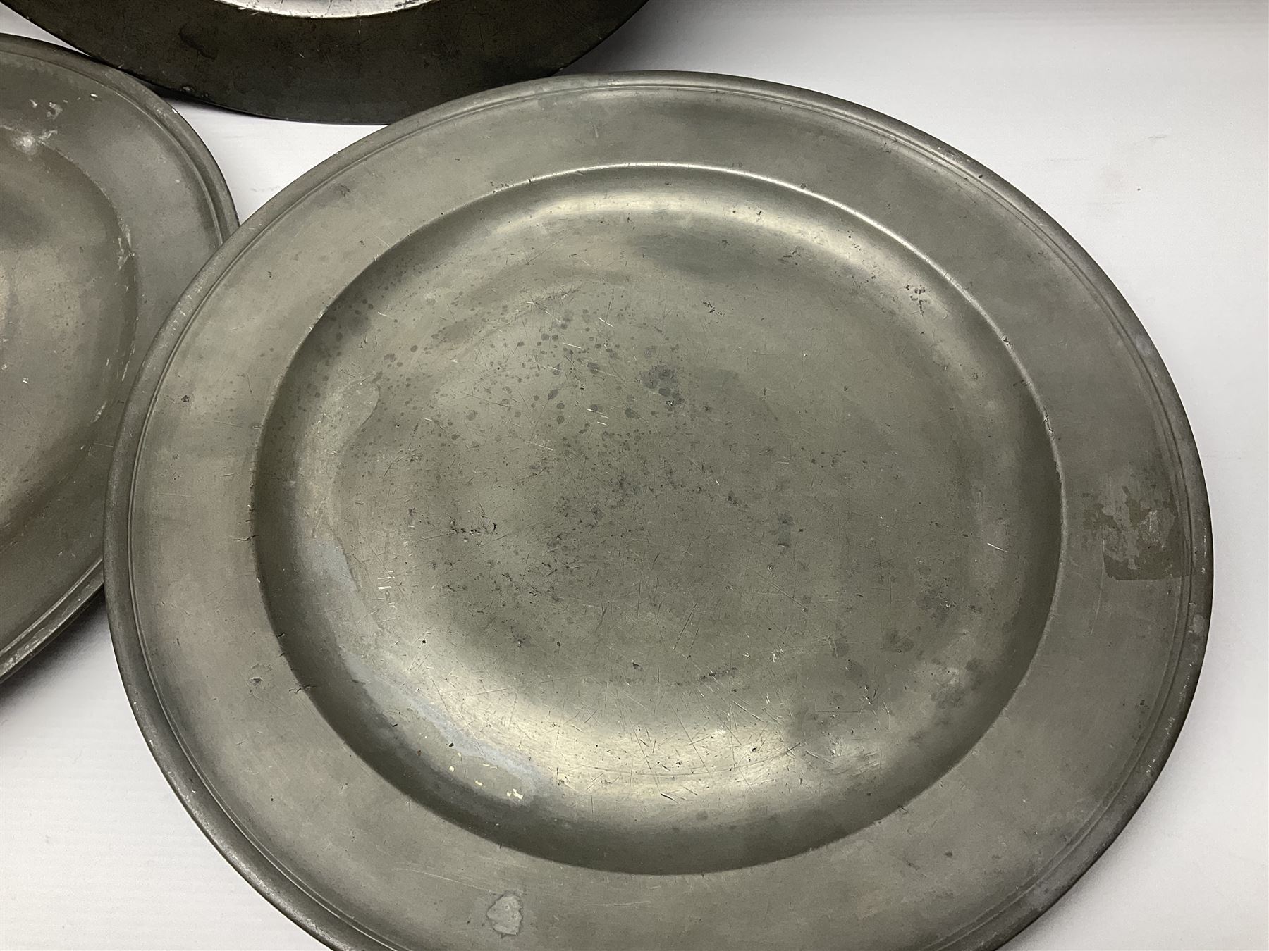 Group of seven 19th century pewter chargers, each of circular form with dished centre, two examples with touch marks verso, each approximately D39cm