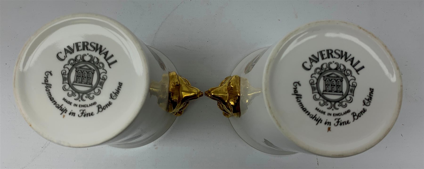  A collection of hunting related items, comprising a pair of Caverswall beakers, each with twin gilt fox head handles, H11.5cm, a limited edition Spode cabinet place depicting 'Drawing the Dingle' after J F Herring Sen, D24cm, and a set of six French shot glasses, decorated with huntsmen on horseback and hounds, H5.5cm.  