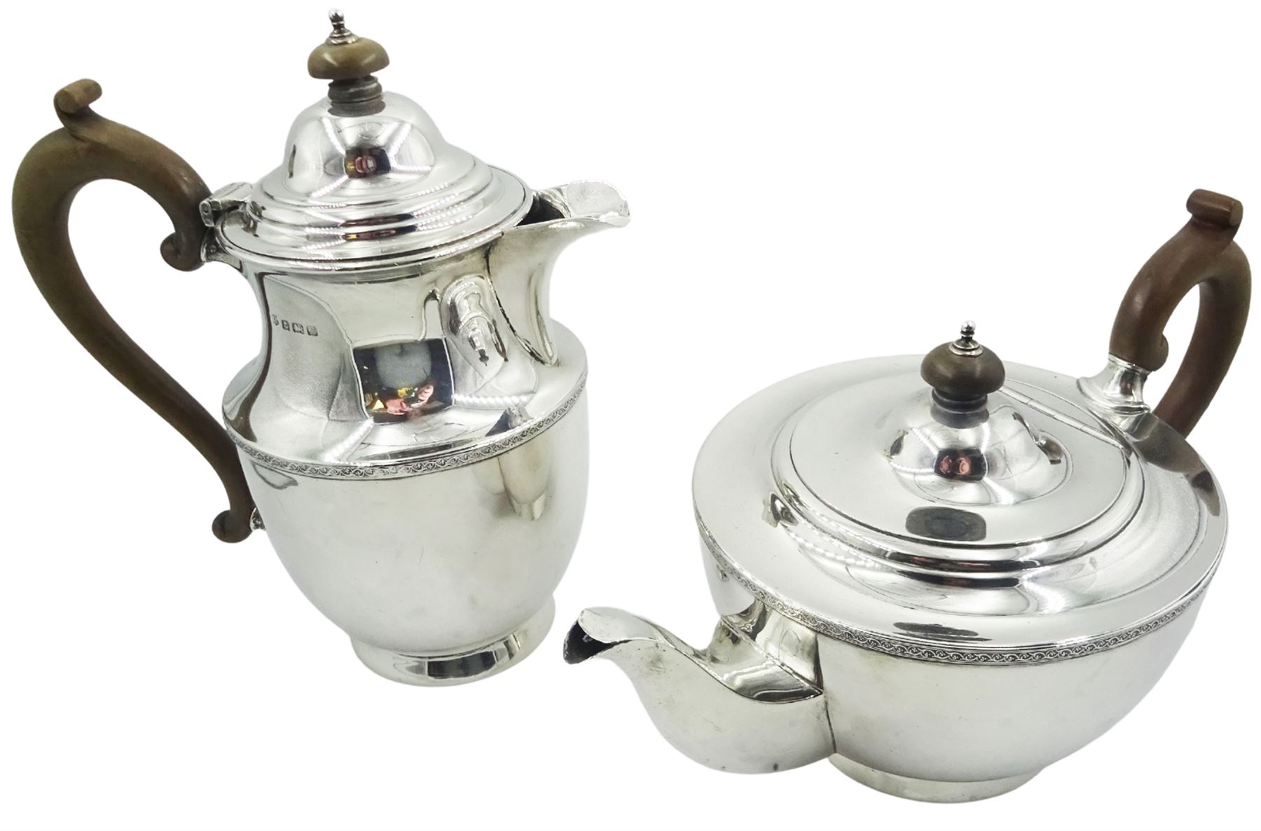 1920's silver teapot and hot water pot, each with foliate scroll band