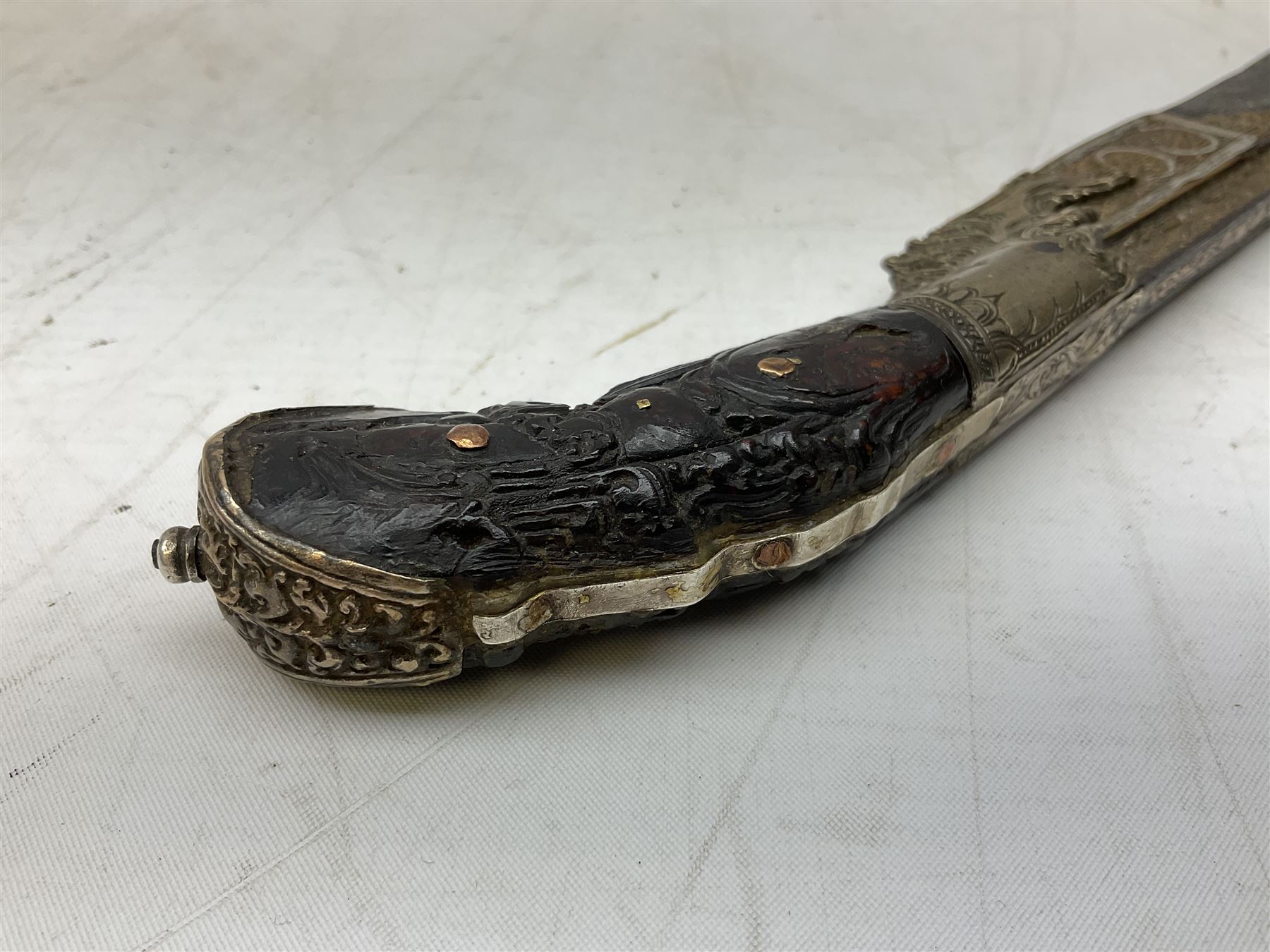 19th century Singhalese knife pia kaetta, the 20cm steel blade inset with yellow and white metal, with metal mounted carved pistol grip, in plain wooden scabbard L33cm overall