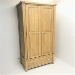 Solid oak wardrobe, two doors enclosing hanging rail above single drawer, stile supports, W111cm, H196cm, D63cm