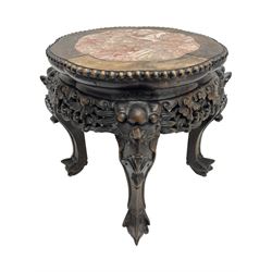 Early 20th century Chinese hardwood and marble top jardinière or urn stand, shaped circular top with bead edge over pierced and carved foliate rails, the supports carved with dragon masks and fanned foliate decoration, on ball and claw feet