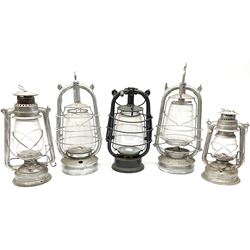 Five cast metal oil lanterns, to include one black painted example, tallest H43cm
