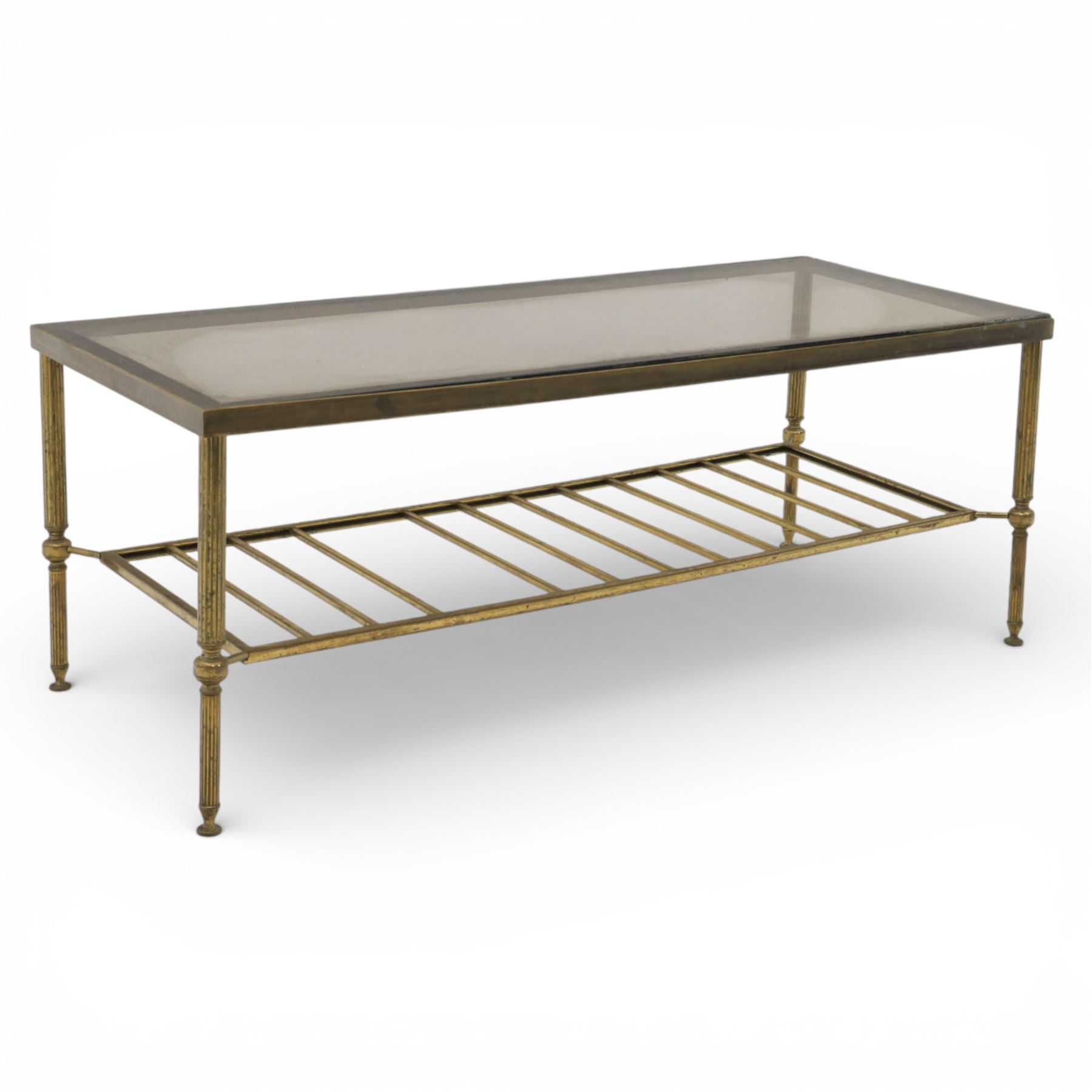 20th century brass and glass topped coffee table, the rectangular glass top within brass frame, upon four reeded legs united by lower slatted under tier 