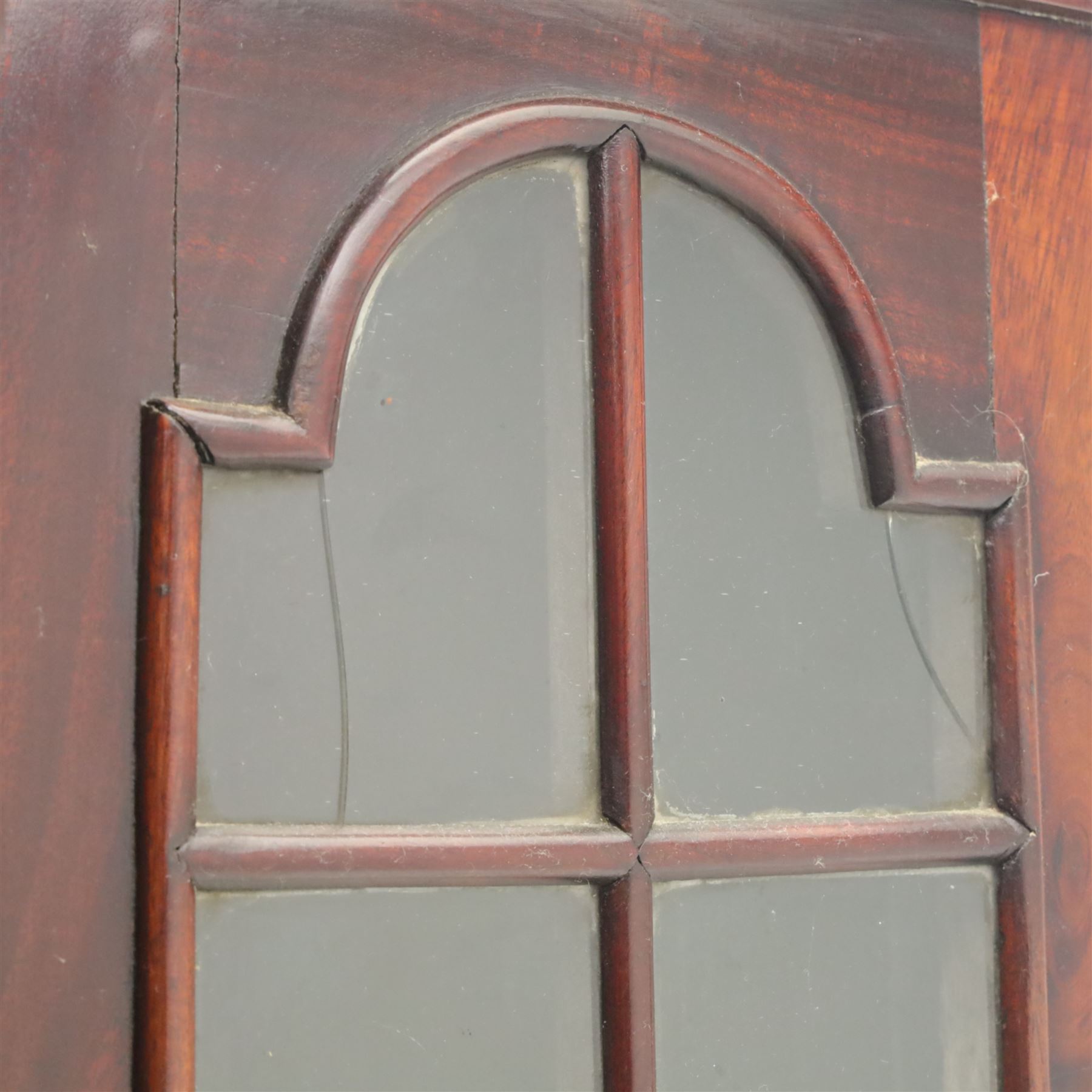 Late 19th century Continental bombe cabinet on chest, shaped moulded cornice with carved cresting, the upper section enclosed by a pair of arched glazed doors with astragal glazing revealing a shelved interior, the lower section fitted with four graduating drawers with rococo-style metal handles, serpentine front and sides, raised on scroll and paw feet