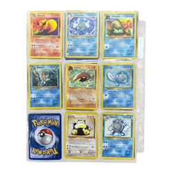 Collection of mainly vintage Pokemon cards including Charizard Base Set Holographic number 4/102 and two Ancient Mew 2000 promo cards, some housed within plastic wallets and some loose
