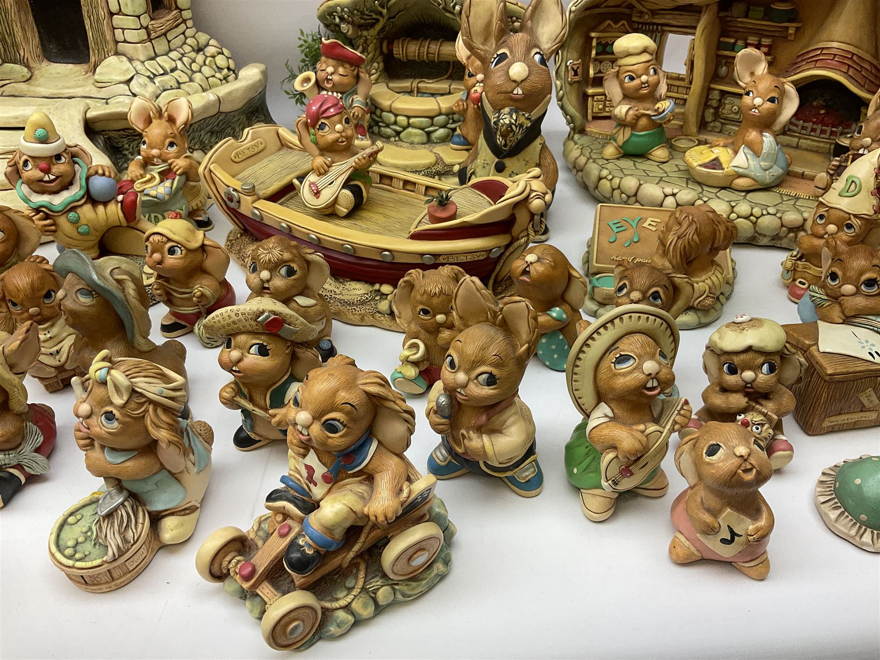 Extensive collection of Pendelfin rabbits and stands, to include Betsy Barge, Fruit Shop, Uncle Soames, Event Piece etc, many with original boxes 