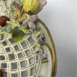 19th Meissen style centrepiece, with pierced lattice work sides and decorated in relief with fruit and floral sprigs, upon four scrolled feet, with spurious mark beneath H9cm D31cm