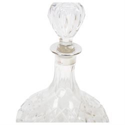 Two modern silver mounted glass decanters, the first a cranberry glass example, with fluted body, clear stopper and silver collar, hallmarked Barker Brothers Silver Ltd, Birmingham 2001, together with a clear cut glass example with silver collar, with import marks for London 1985, tallest H25.5cm