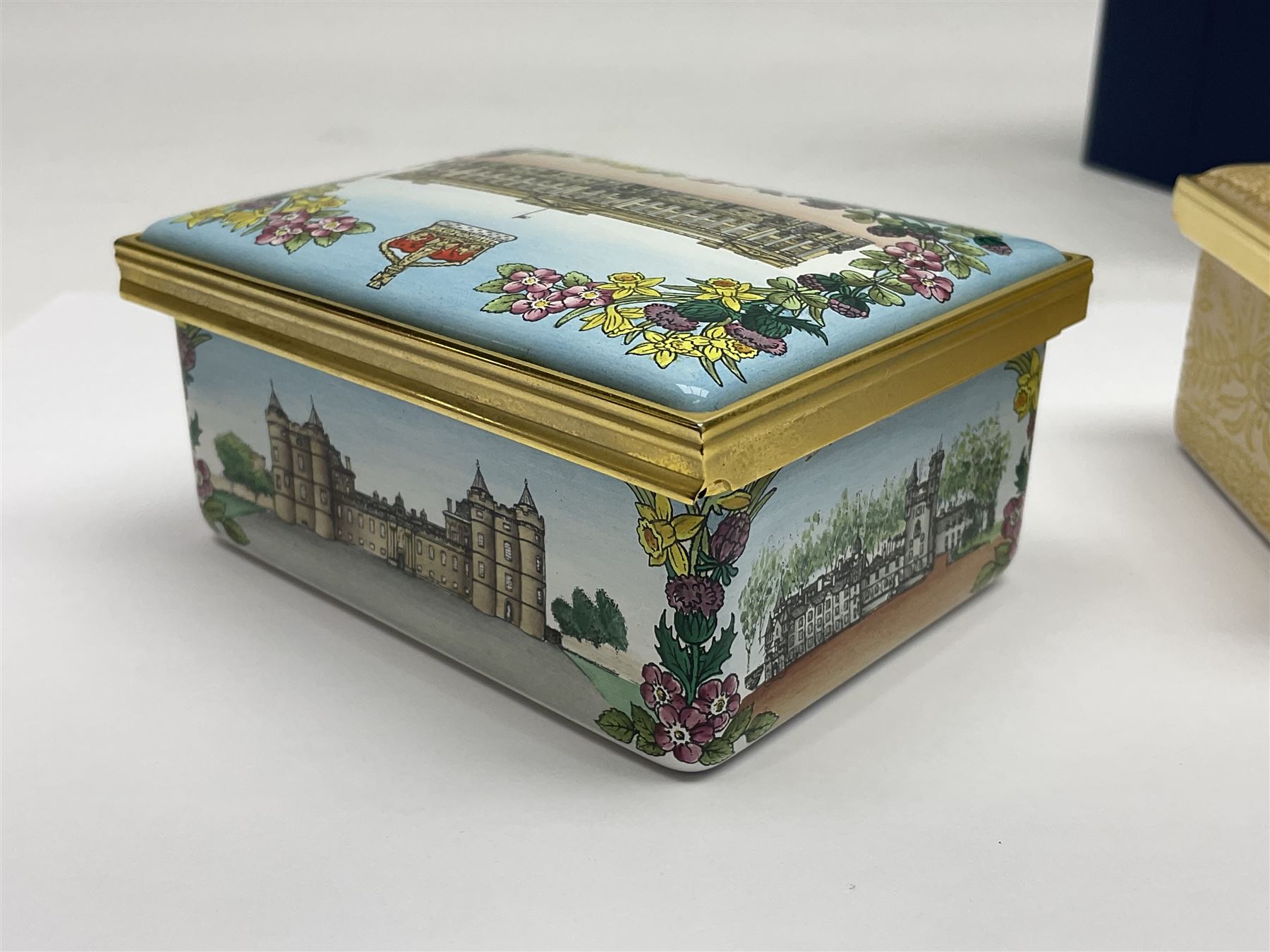 Two Halcyon Days enamel boxes, both of rectangular form, the first depicting Buckingham Palace, 'To Celebrate the Golden Jubilee of Her Majesty Queen Elizabeth', the second depicting the marriage of The Queen and Prince Philip, in celebration of their Diamond Wedding Anniversary, H4cm, W8.5cm, both boxed
