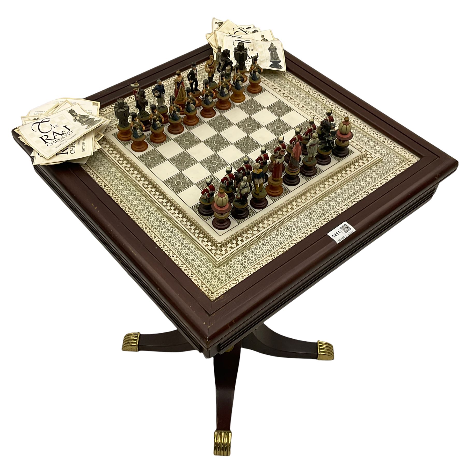 Franklin Mint Indian ' The Raj ' chess set with marble effect chess board within a mahogany stained frame raised on a brass mounted pedestal base with single fitted drawer, the playing pieces depicting figures from the 1857 Raj mutiny 52cm square H68cm