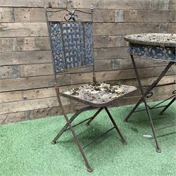 Circular metal garden table with tile top and matching chair, weathered