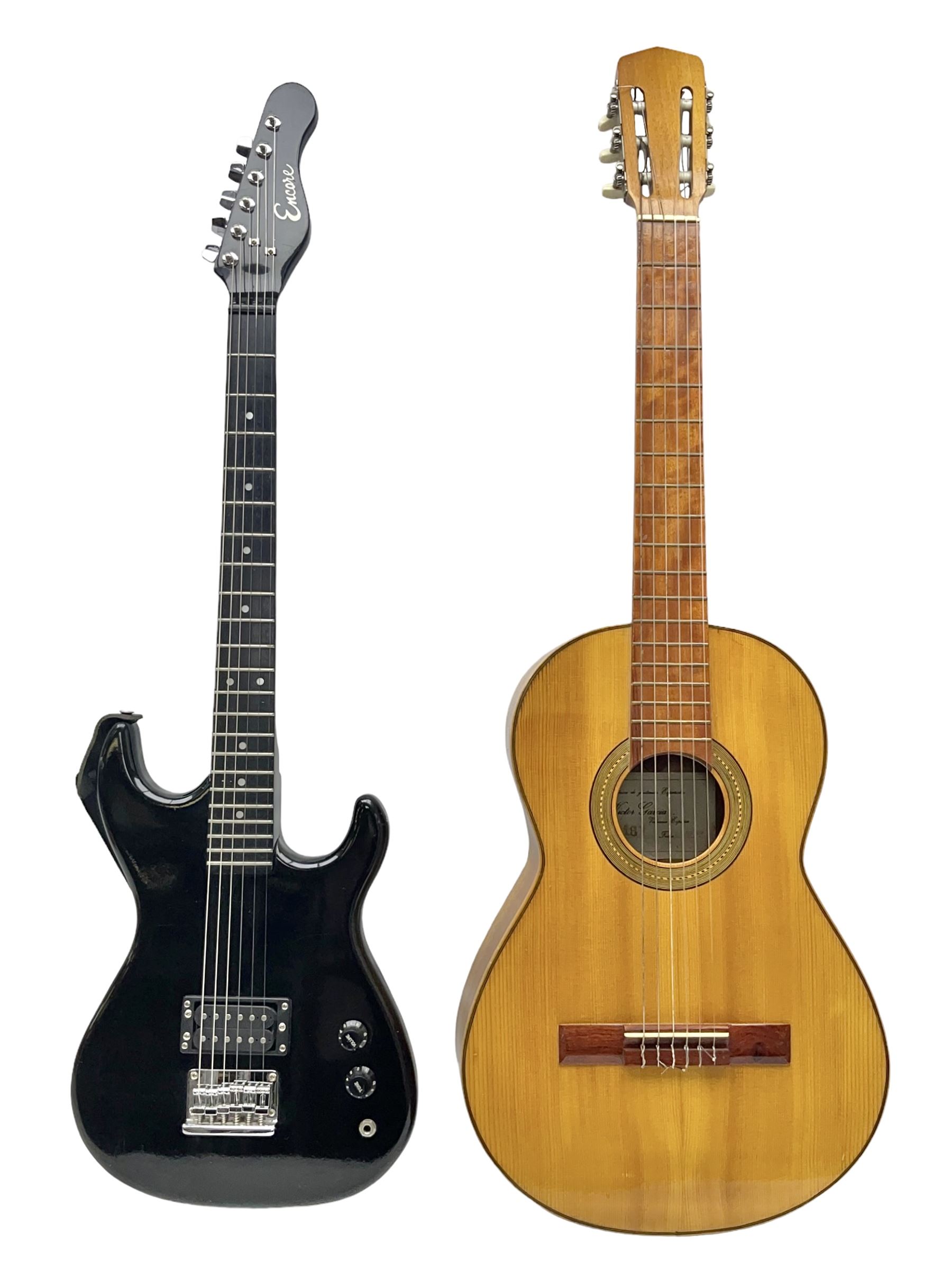 Encore black electric cut-away guitar L96cm; and Spanish Victor Garcia model 187 acoustic guitar, bears label dated 1972 L99cm; each in soft carrying case (2)