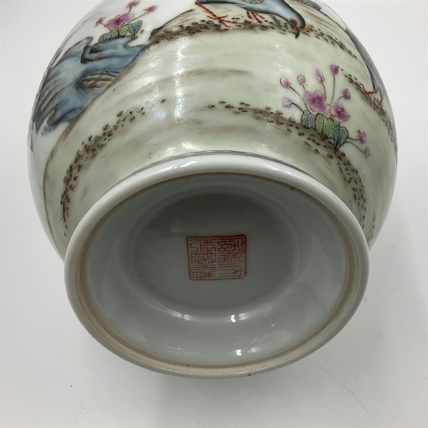 Pair of Chinese Republic porcelain vases, each painted in Famille Rose enamels with pairs of pigeons amidst peony, rock, flowering plants and leafy branches, possibly Qianlong seal beneath, H22cm 
