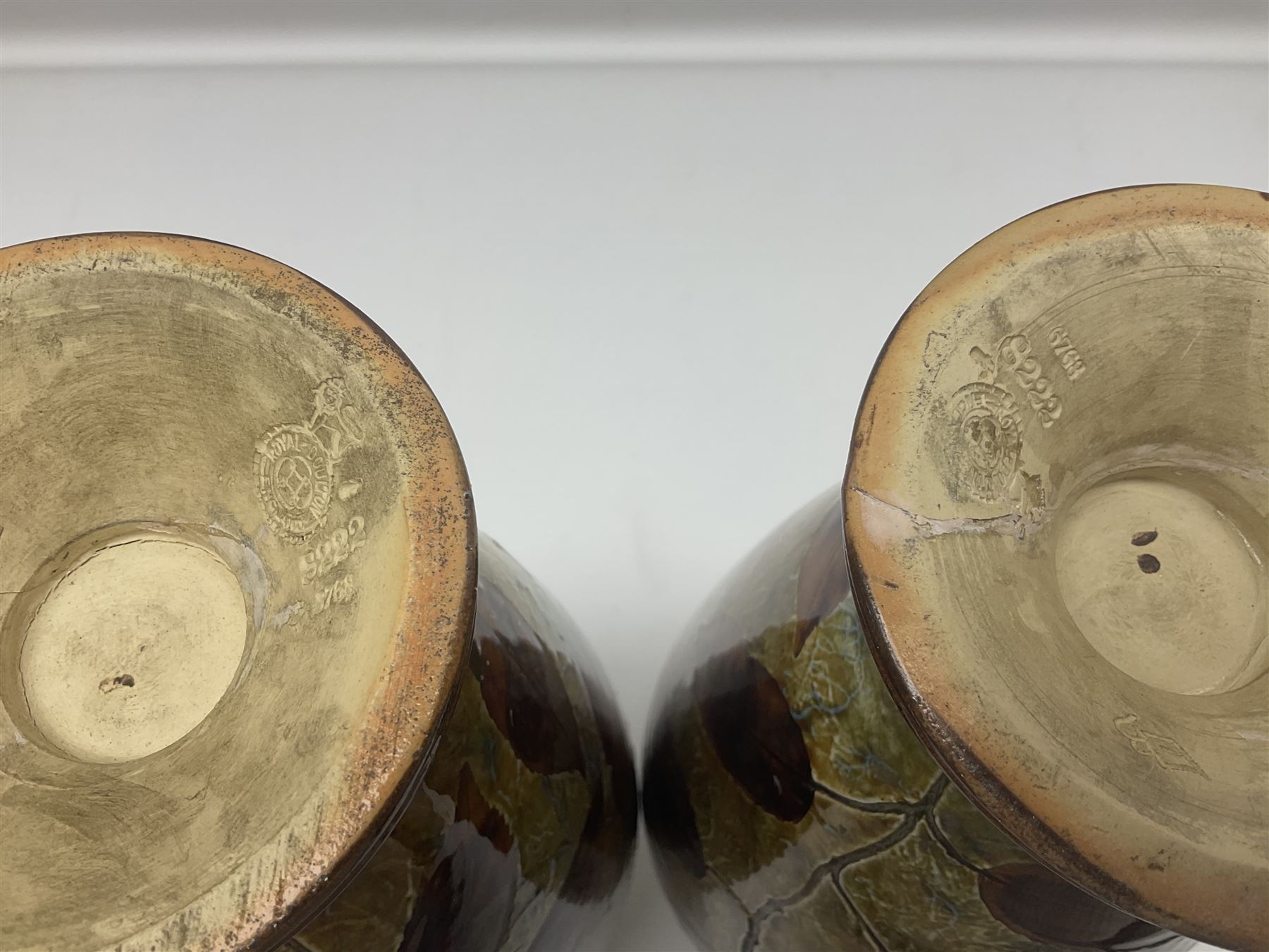Pair of Royal Doulton Stoneware Vases with leaf decoration, by Ethel Beard, impressed marks to base numbered 6768 and 8222 and initials EB, H32cm