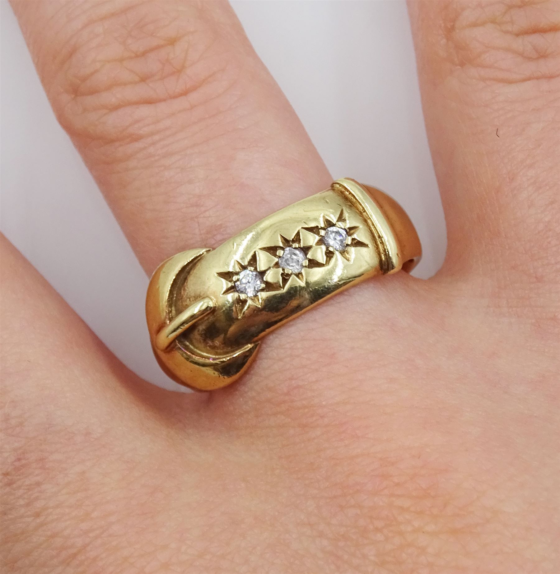 9ct gold gypsy set three stone cubic zirconia buckle ring, hallmarked
