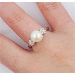 9ct white gold pearl and diamond ring, the central white cultured pearl, with two clusters of round brilliant cut diamonds either side, stamped 375