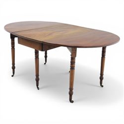 Early 20th century mahogany inlaid oval drop leaf dining table, the crossbanded and line inlaid top with twin hinged leaves (extends to 165cm), plain frieze centred by inlaid panel with stylised star motif, raised on four ring turned tapering supports terminating in brass caps and castors