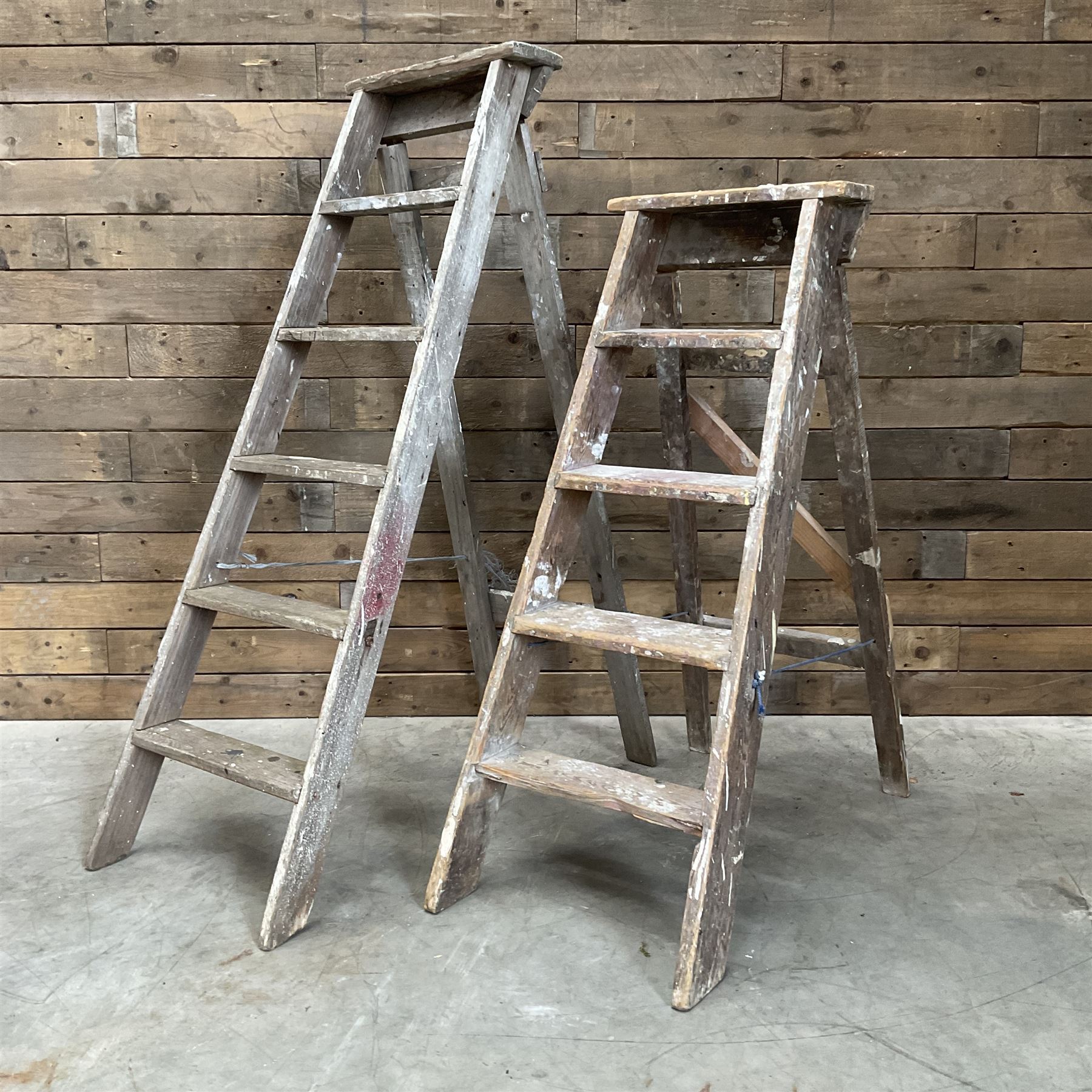 Large timber work bench with central glass section, and two pairs of vintage wooden step ladders (3)
