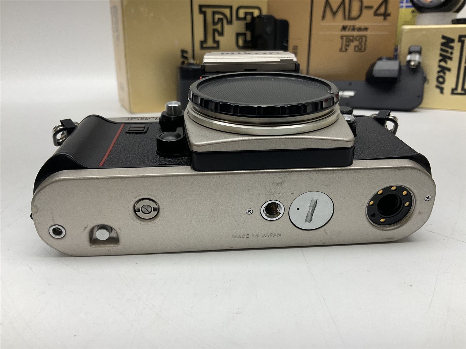 Nikon F3T camera body, in champagne/ titanium colourway, serial no. T8215031, with 'Nikon Nikkor 50mm 1:1.4' lens, Nikon MD4 motor drive, serial no. 156592 and Nikon MK-1 Firing range converter, all with original boxes 