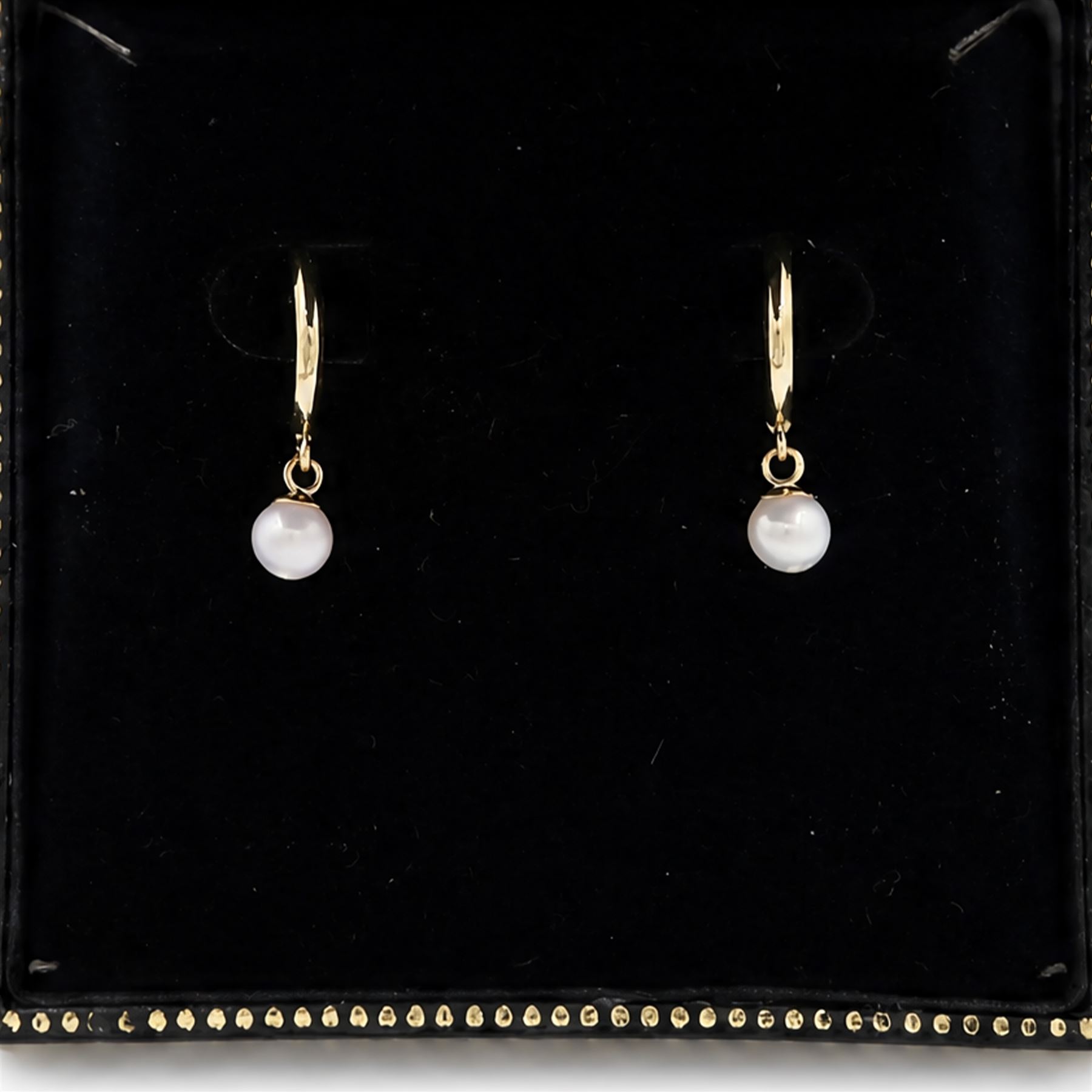 Pair of 9ct gold pearl pendant earrings, each stud set with a single white pearl, stamped 375