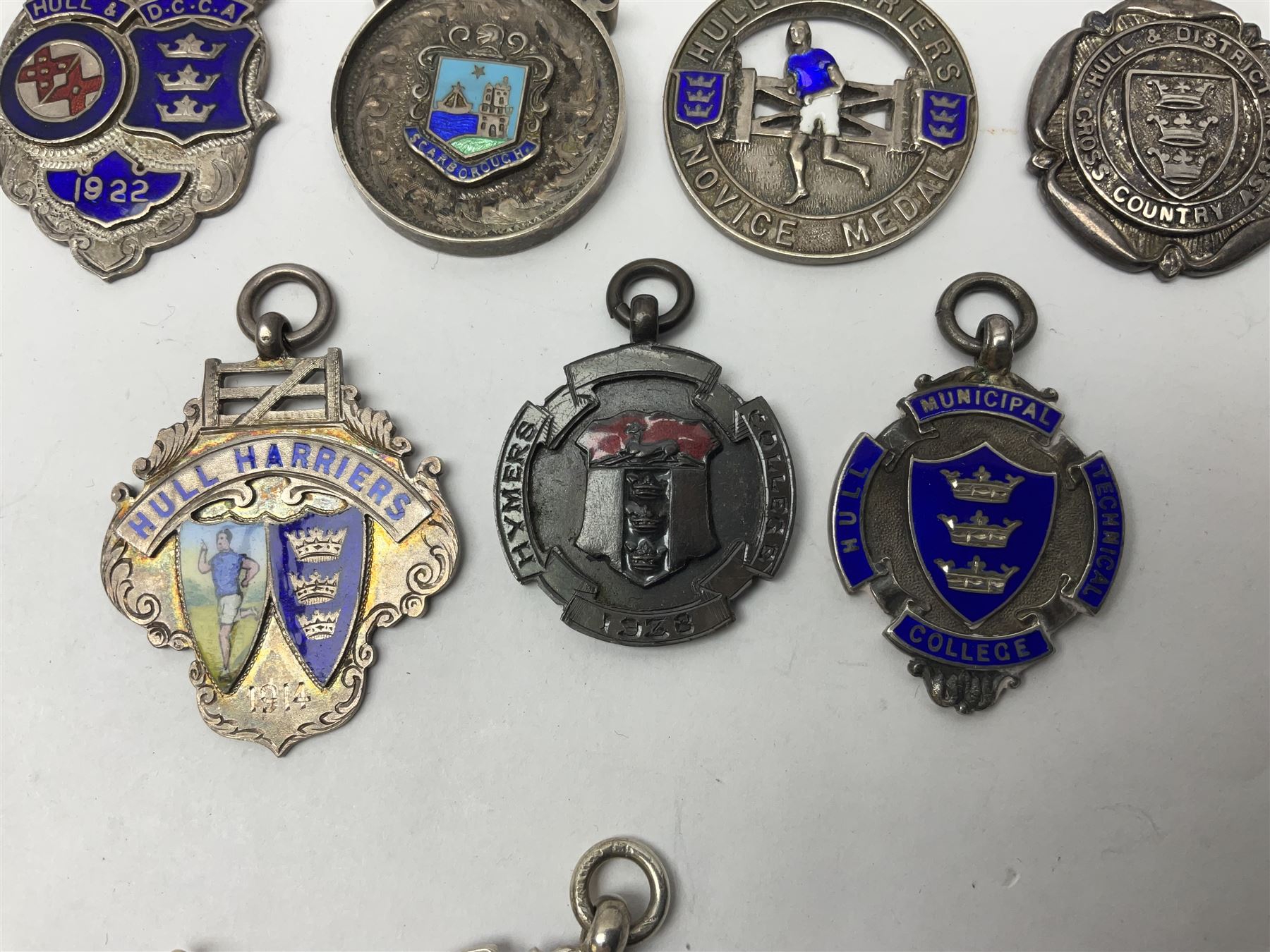 9ct gold enamel 'Hull' charm, together with eight silver fob medallions, six with enamel decoration relating to Hull and one Scarborough example, all hallmarked 