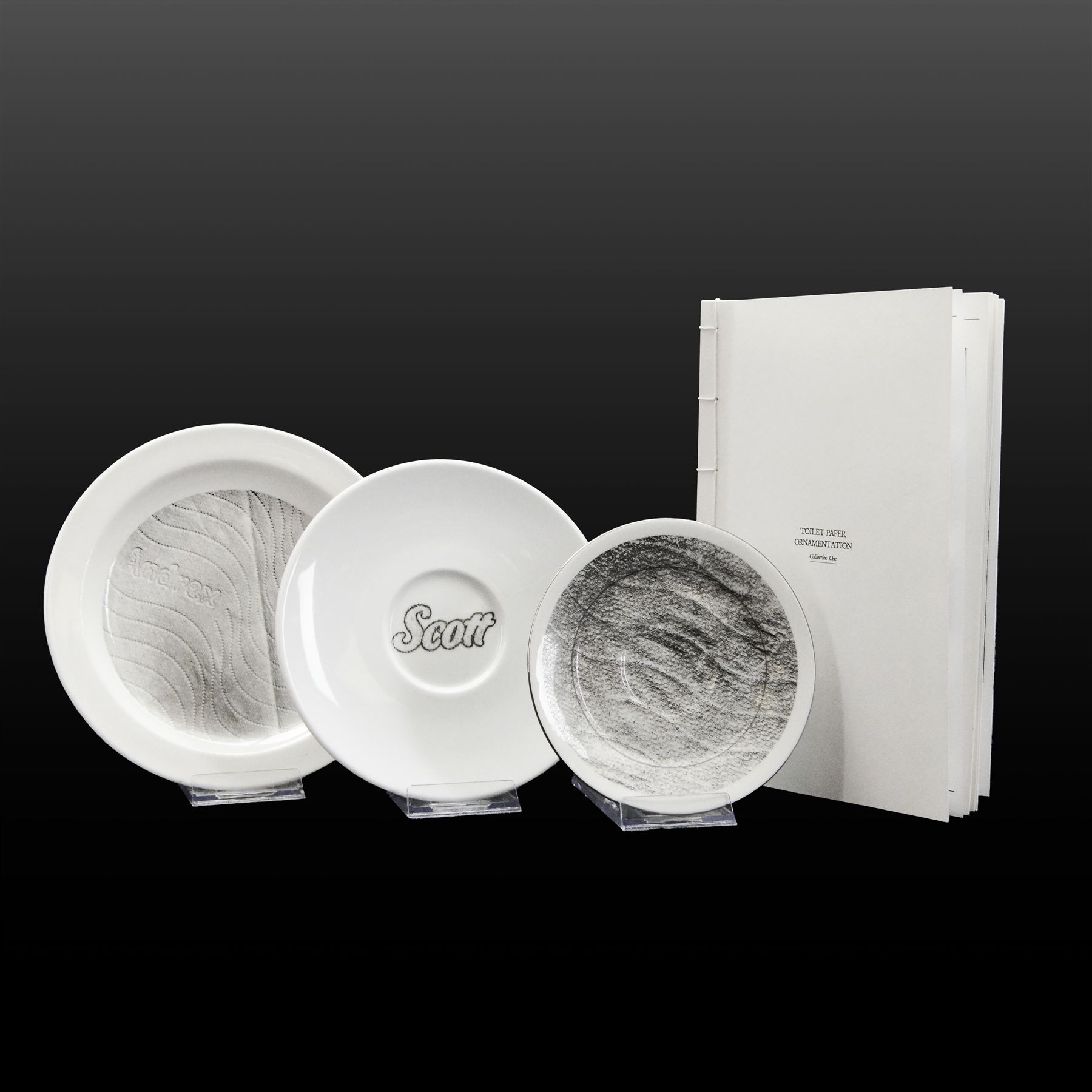 Alice Aldis (British 2002-); 'Toilet Paper Ornamentation - Collection One', hand-bound catalogue; together with three transfer-printed plates, largest D20cm 