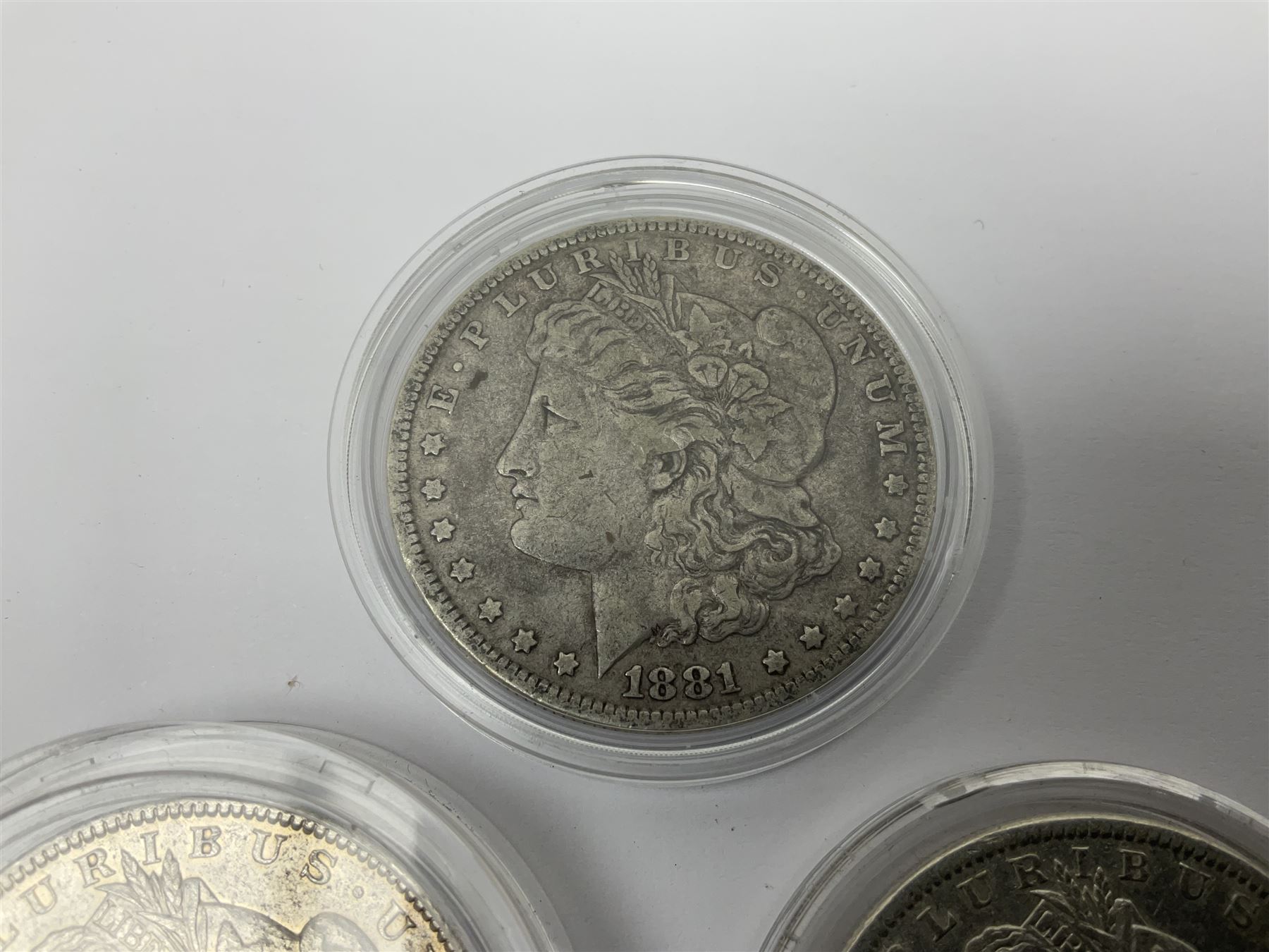 Three United States of America silver Morgan dollar coins dated 1881 O, 1882 and 1882 O