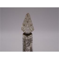 Two silver mounted dressing table jars, one in the form of a heart, both with embossed silver covers and cut glass bodies, hallmarked, together with two smaller examples, one set with mother of pearl, three silver mounted glass scent bottles, including an example with prunus blossom decoration, stamped Sterling, tallest bottle H17cm