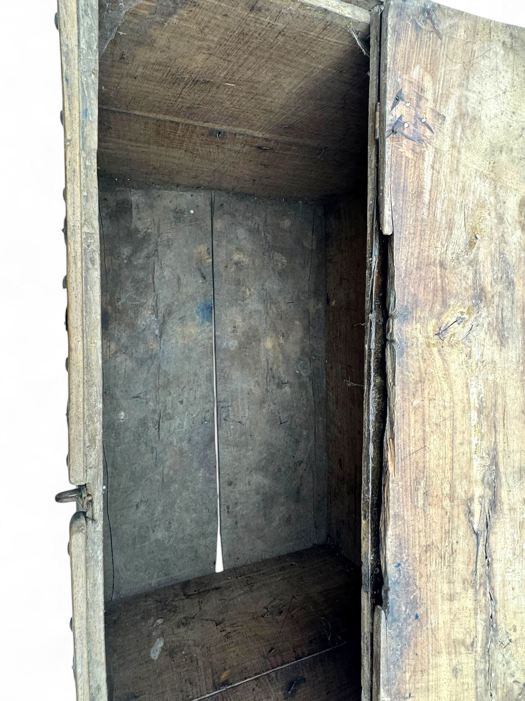 Late 19th century Afghan carved hardwood storage chest, the hinged plank top enclosing large internal storage space, geometric carvings to the front panels decorated with rows of riveted iron bosses