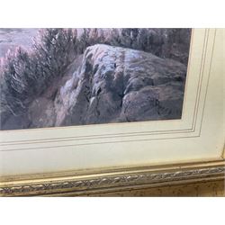 Two large gilt frame prints, one of a winter landscape and one of a mountainscape with highland cows