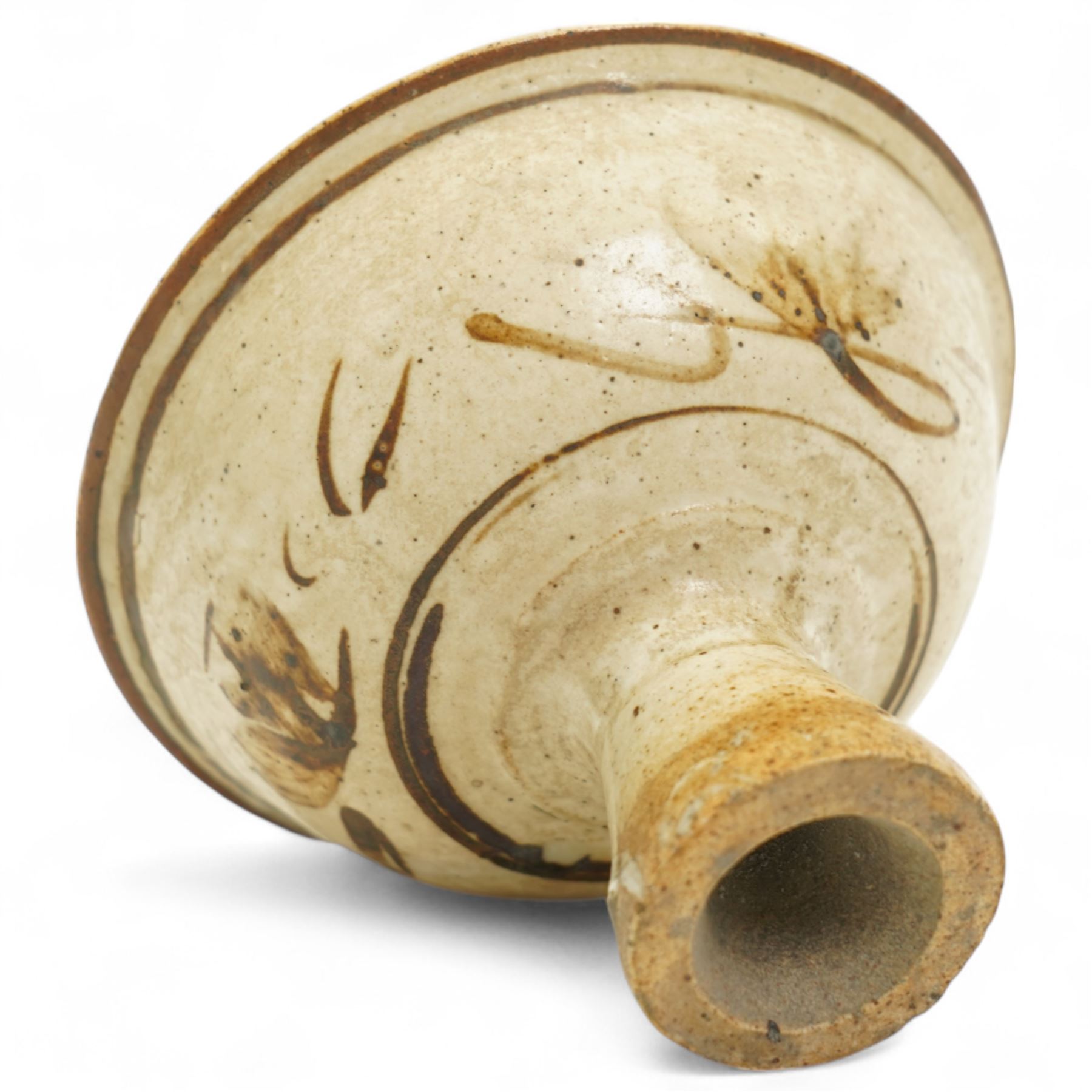 Chinese Song Dynasty (960–1279) Cizhou polychrome decorated wine stem cup, deep rounded sides over tall flared foot, decorated in iron-brown slip with stylized floral spray on a creamy-white slip ground beneath a clear glaze, base of foot unglazed, W11cm H8cm
