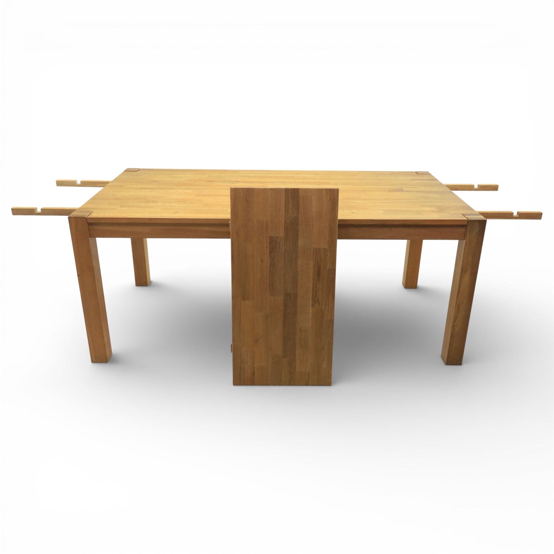 Solid light oak extending dining table with single leaf, and set of six chairs