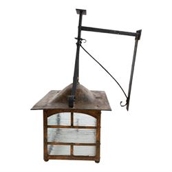 20th century, Arts and Crafts style copper porch lantern, of rectangular form, with cast iron scrolling wall fittings