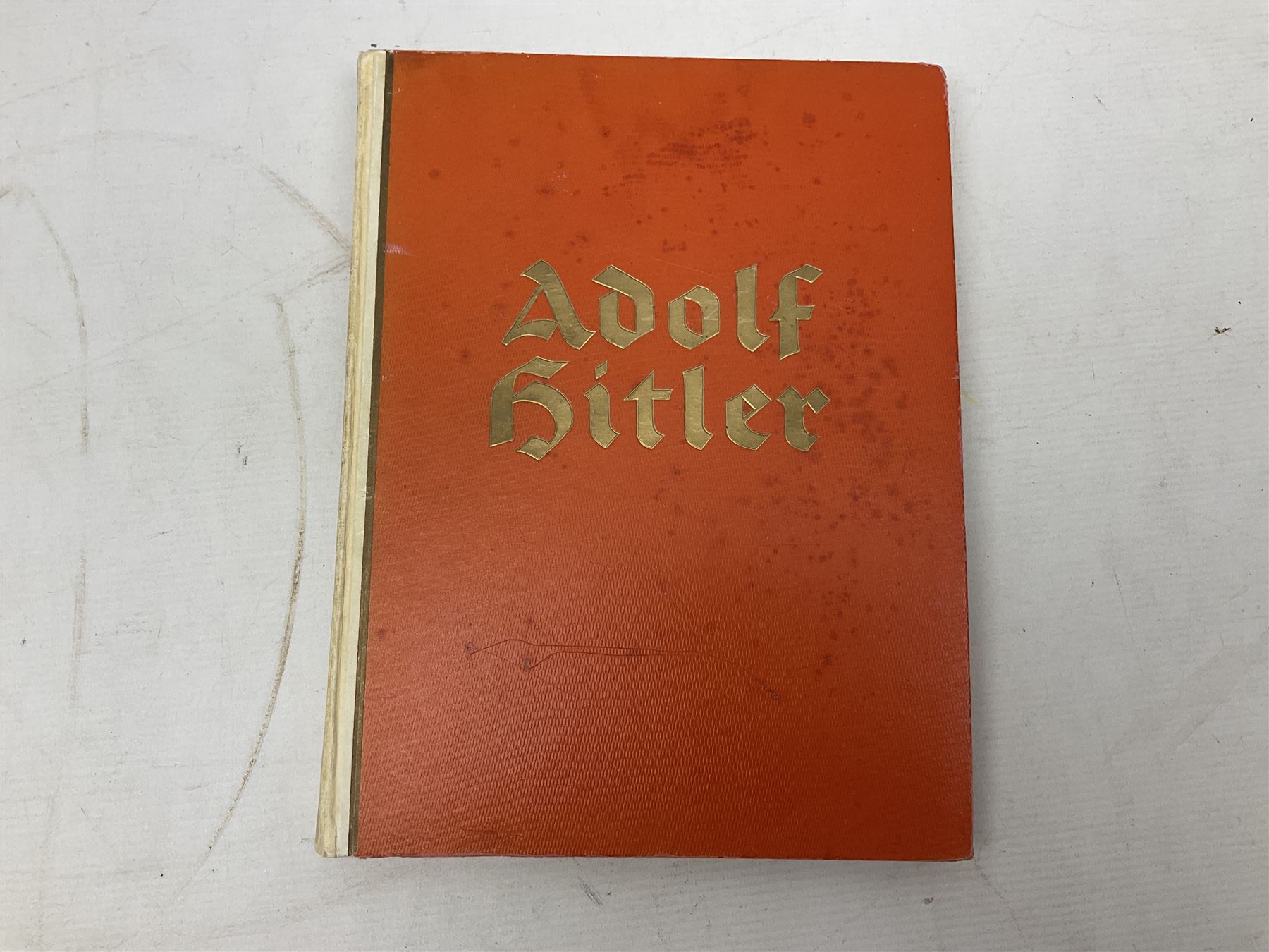 Adolf Hitler, Bilder aus dem Leben des Fuhrers [Pictures from the Life of the Fuhrer], Herausgegeben vom Cigaretten / Bilderdienst, Hamburg / Bahrenfeld, 1936, an album of two hundred tipped-in cards bearing photographs by Heinrich Hoffman, originally collected with cigarettes, 31 cm x 24 cm; together with a Waffen-SS book 'Wenn alle Bruder schweigen'; Hamburg 1939-1945; and two other booklets