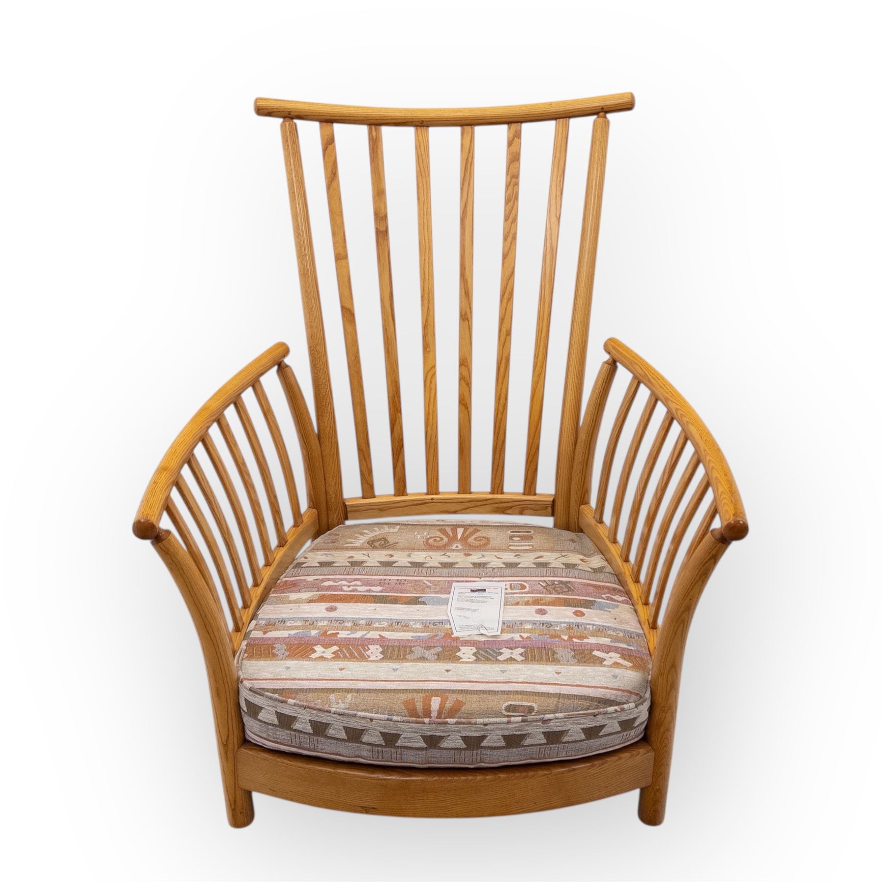 Ercol - Renaissance ash and elm high back armchair, upholstered in geometric Kilim patterned fabric with padded back, seat and arm cushions, curved stick back frame and turned supports