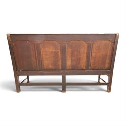 19th century Gothic Revival heavily carved oak settle or hall bench, the high quadruple back with moulded cresting rail over a frieze carved with stylised dolphin and sea creature motifs, the panels decorated with griffin and bird motifs with floral dividing rails, the shaped apron similarly carved with scaly sea beasts, on three cabriole front-supports united by stretchers